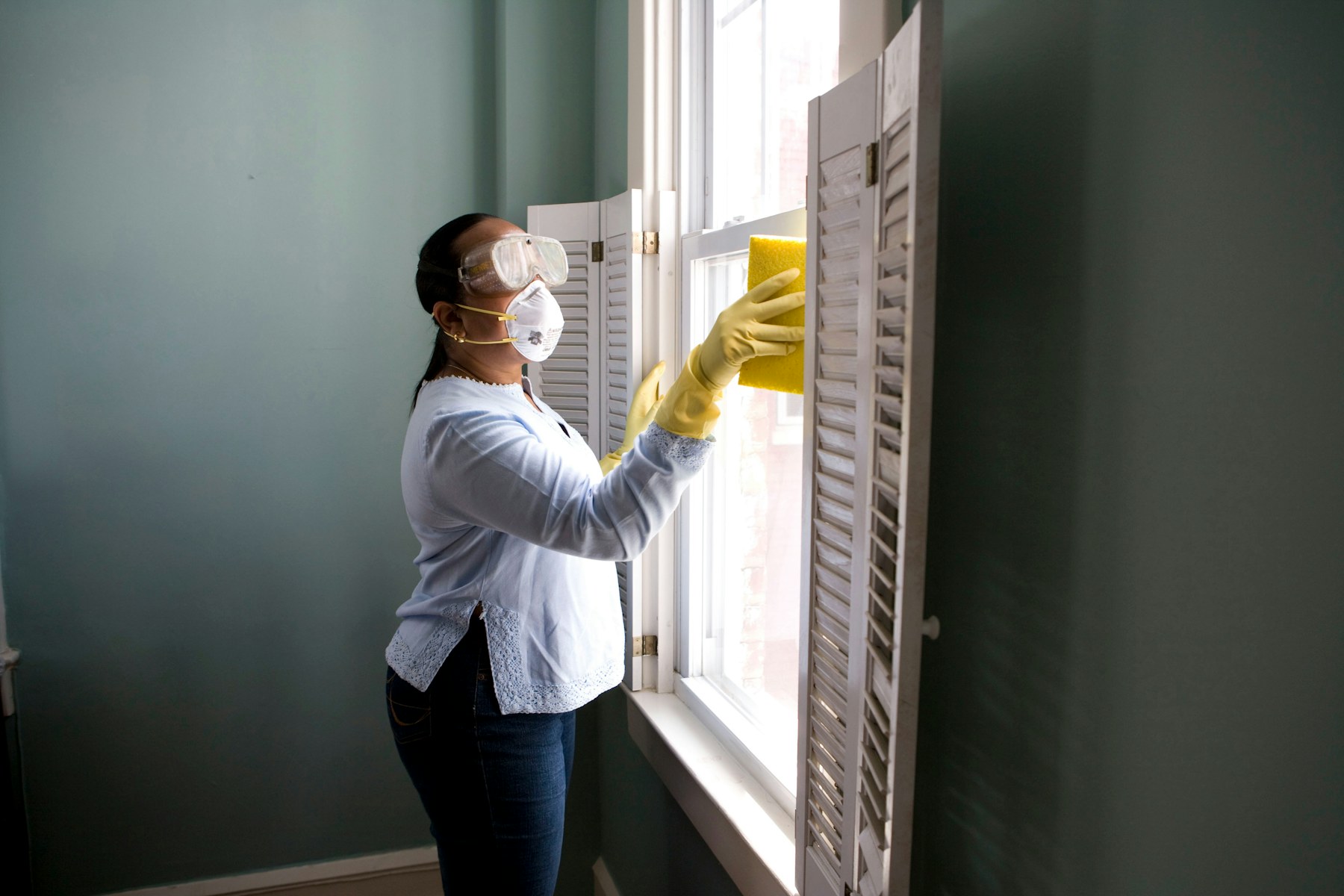 Professional cleaner maintaining a bright commercial workspace